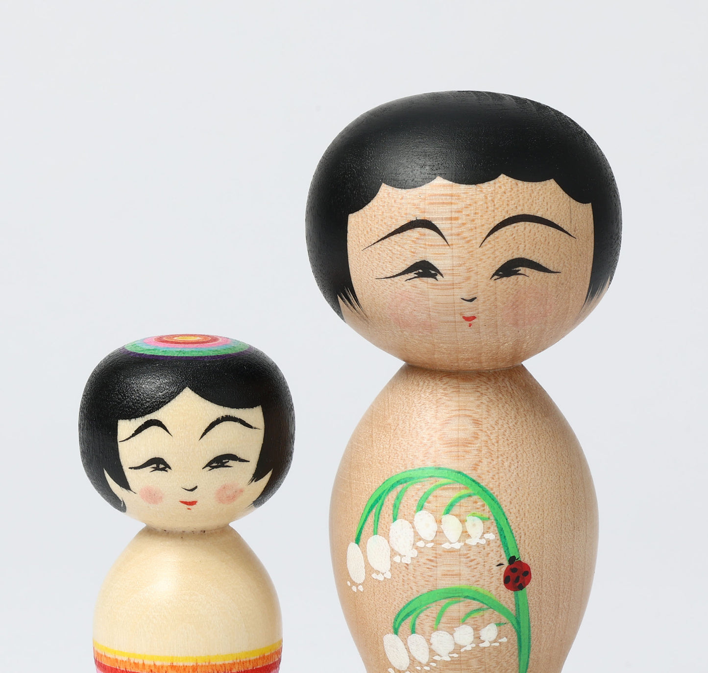 HIRAGA, Teruyuki 平賀輝幸工人 | set of 2 kokeshi dolls-lily of the valley and mini rainbow kokeshi dolls すずらんと虹のミニこけし |  Sakunami style 作並系 | 10.5cm in height