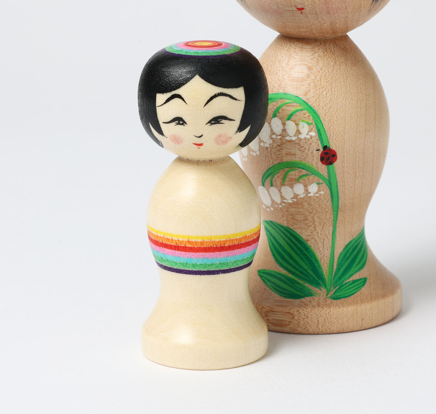 HIRAGA, Teruyuki 平賀輝幸工人 | set of 2 kokeshi dolls-lily of the valley and mini rainbow kokeshi dolls すずらんと虹のミニこけし |  Sakunami style 作並系 | 10.5cm in height